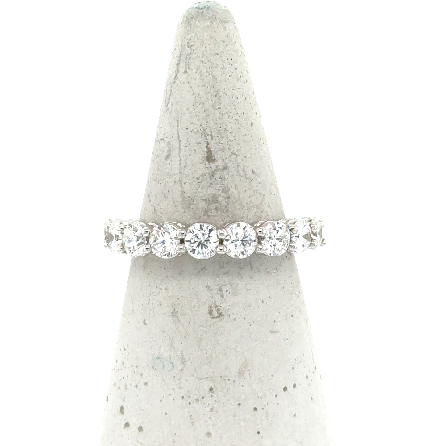 18K white gold band with nine round diamonds in shared-prong setting.
