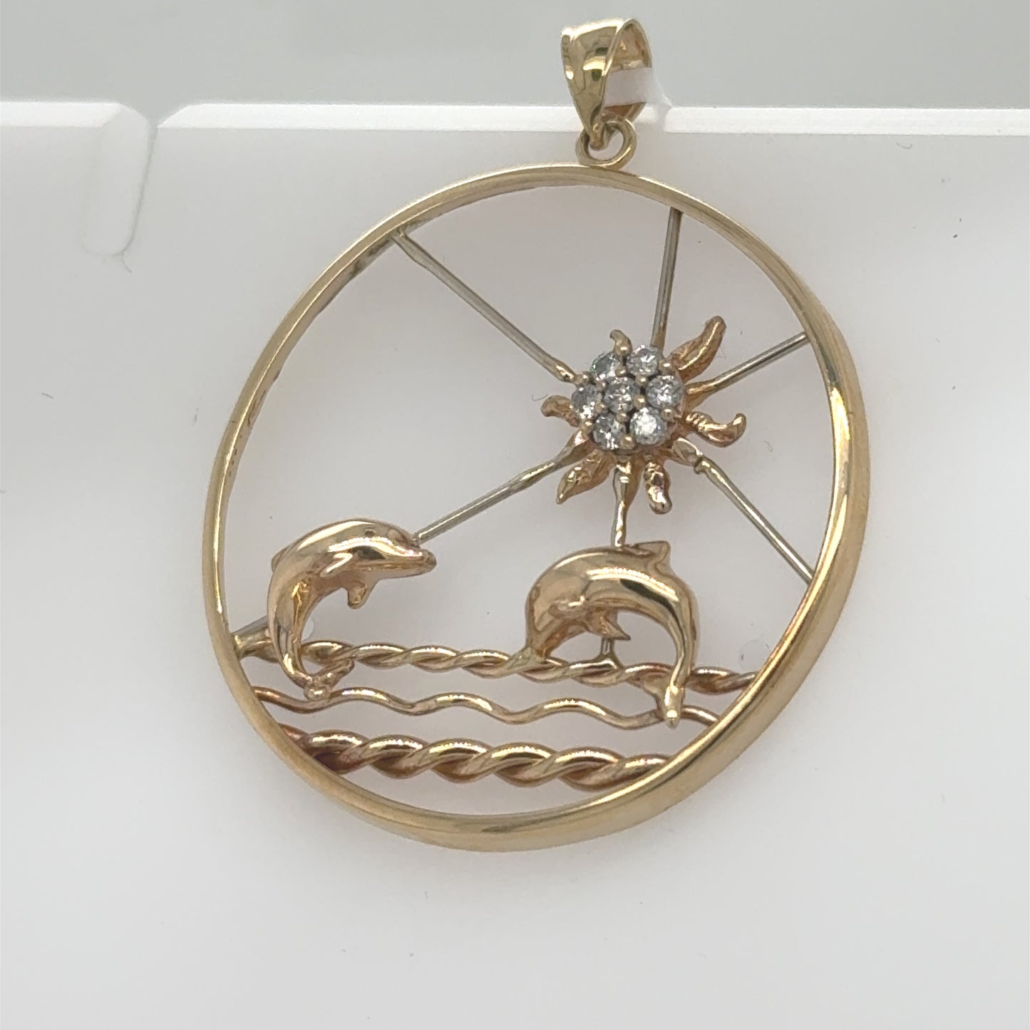 14K yellow and white gold pendant with dolphins and diamond sunburst beach motif.