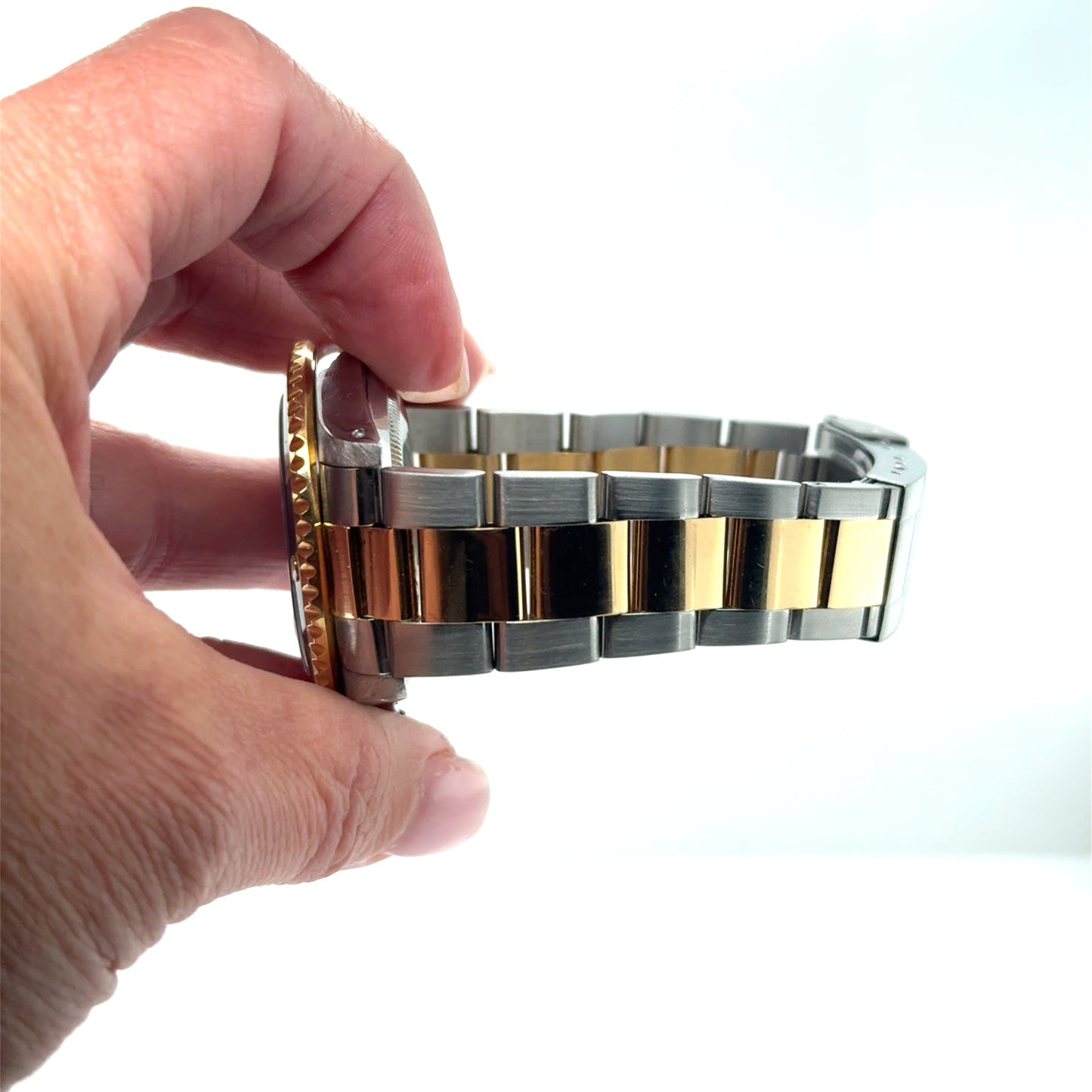 Two-tone stainless steel and yellow gold Oyster bracelet with fluted gold bezel edge.