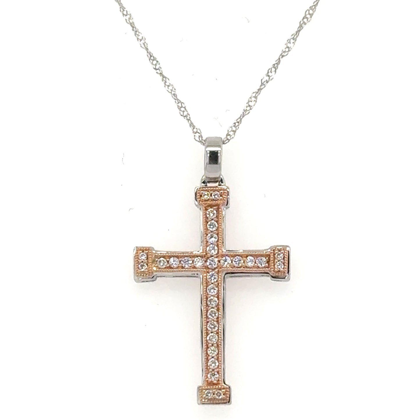 Two-tone white and rose gold diamond cross pendant on twisted rope chain.