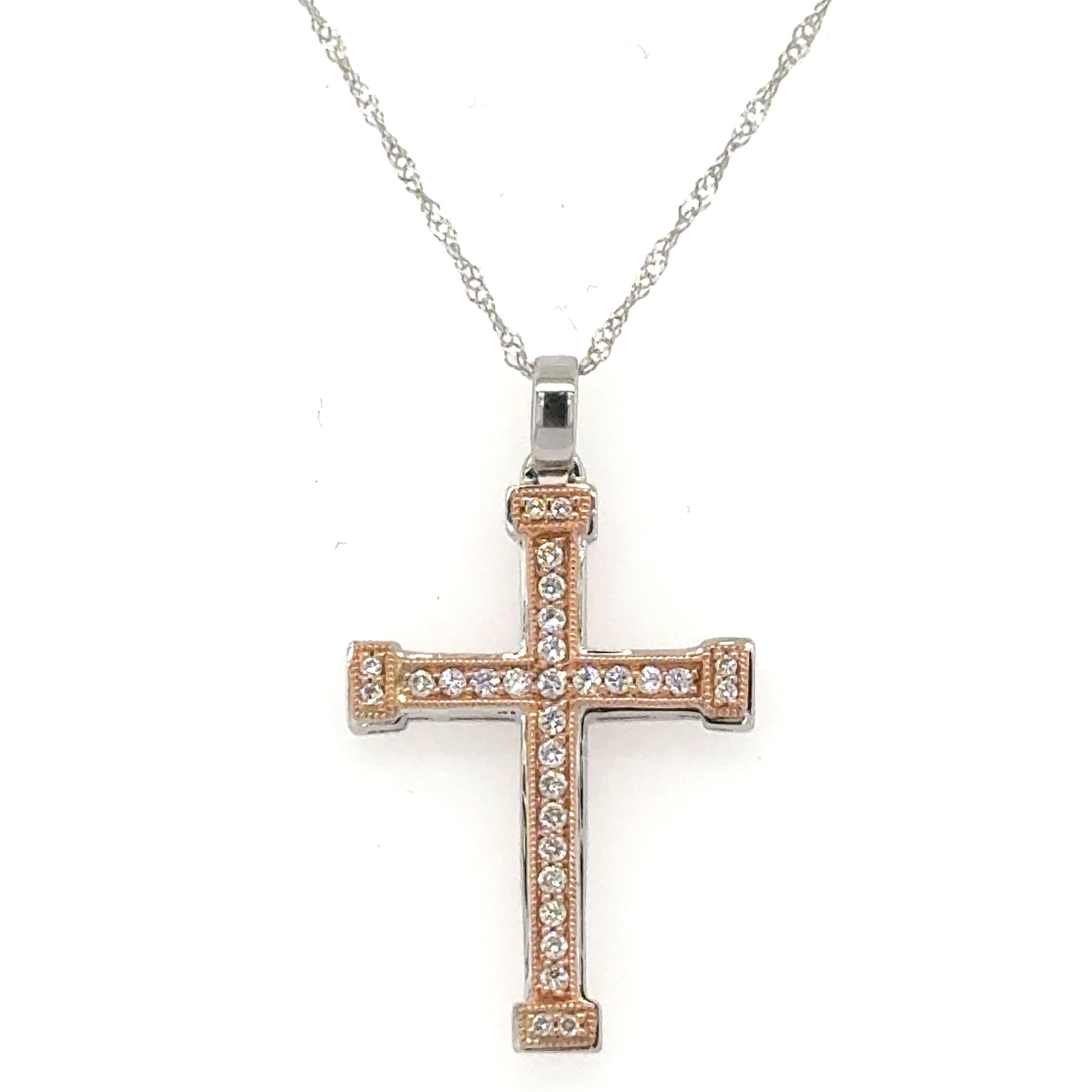 Two-tone white and rose gold diamond cross pendant on twisted rope chain.