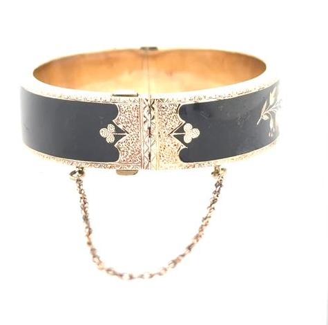 10K yellow gold Victorian bangle with black enamel, seed pearls, and safety chain.