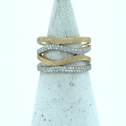 14K yellow gold freeform band with wavy open design and pavé diamonds.