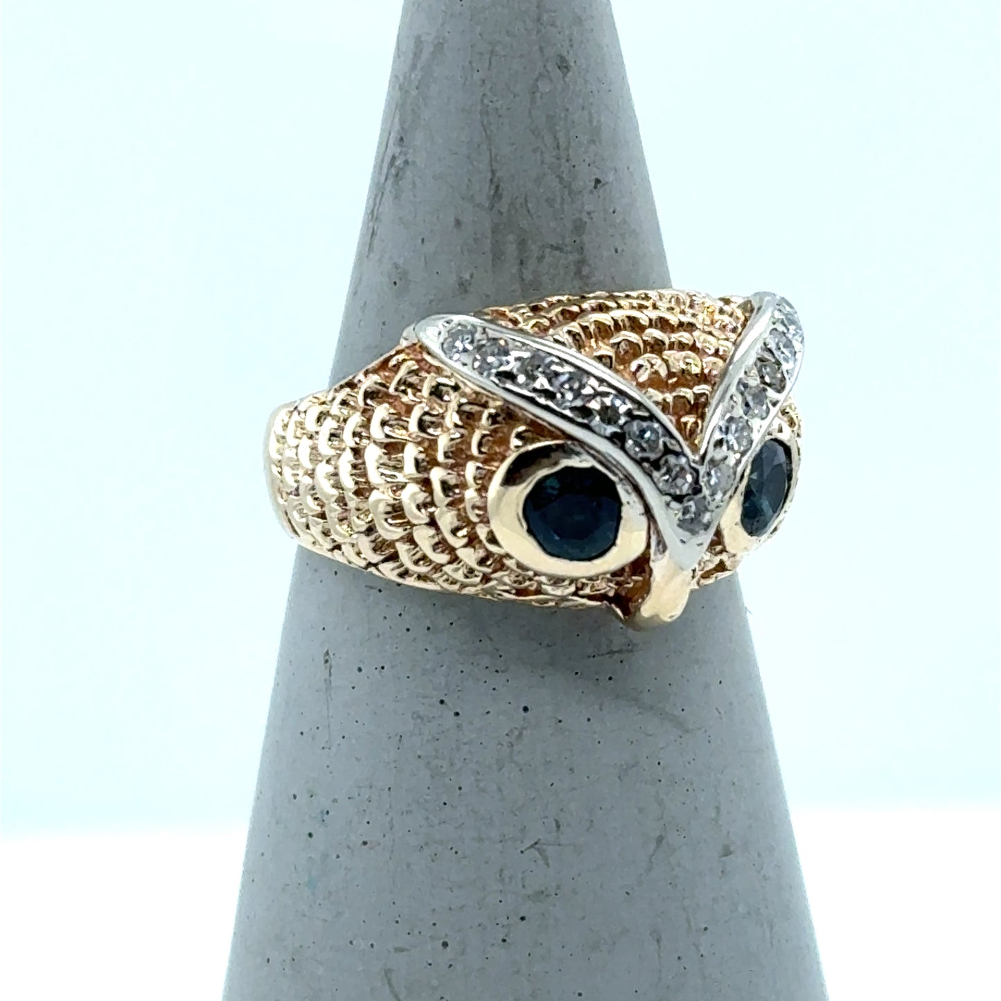 14K yellow gold owl ring with blue gemstone eyes and diamond-set white-gold brows.