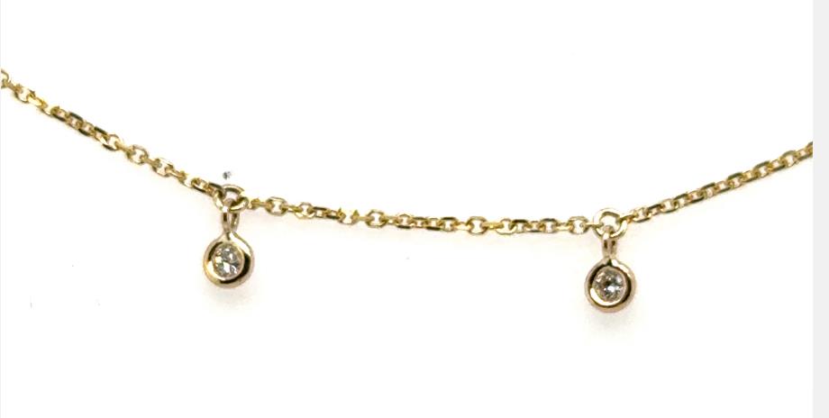Yellow gold cable chain anklet with bezel-set round diamond dangles.