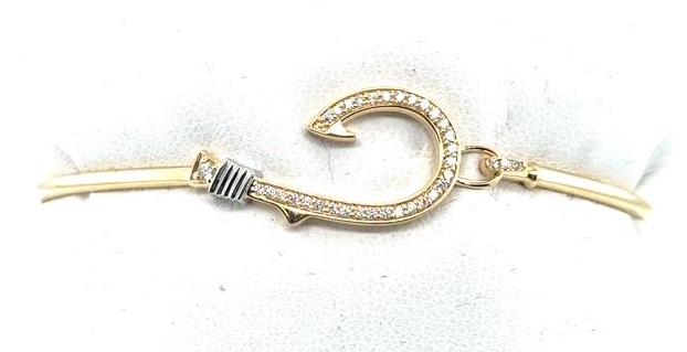Yellow gold bangle with diamond‑pavé fish hook and white gold wrapped detail.