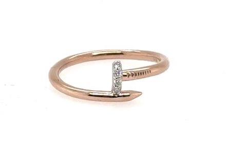 Rose gold nail-shaped ring with a pavé diamond accent on the nail head.