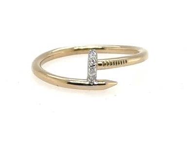 Yellow gold nail-inspired ring with pavé-set round diamonds on the nail head.