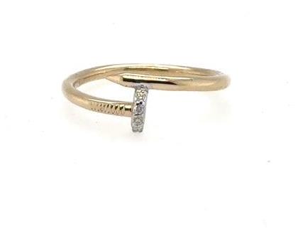 Yellow gold nail-inspired ring with vertical pavé diamond bar and slim band.