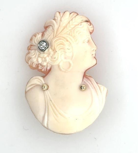 Carved shell bust cameo brooch with round diamond hair pin and gold accents.