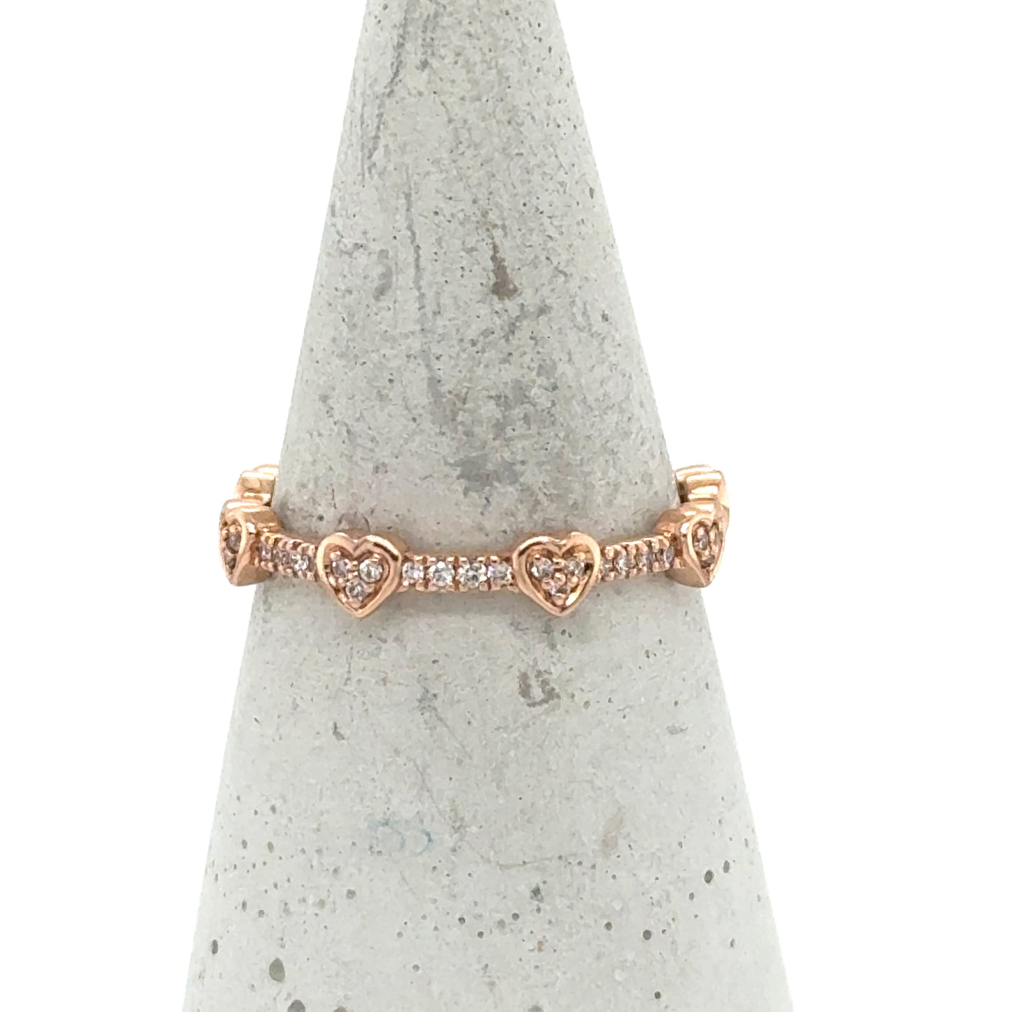 Rose gold 14K eternity band with diamond pavé hearts around the ring.