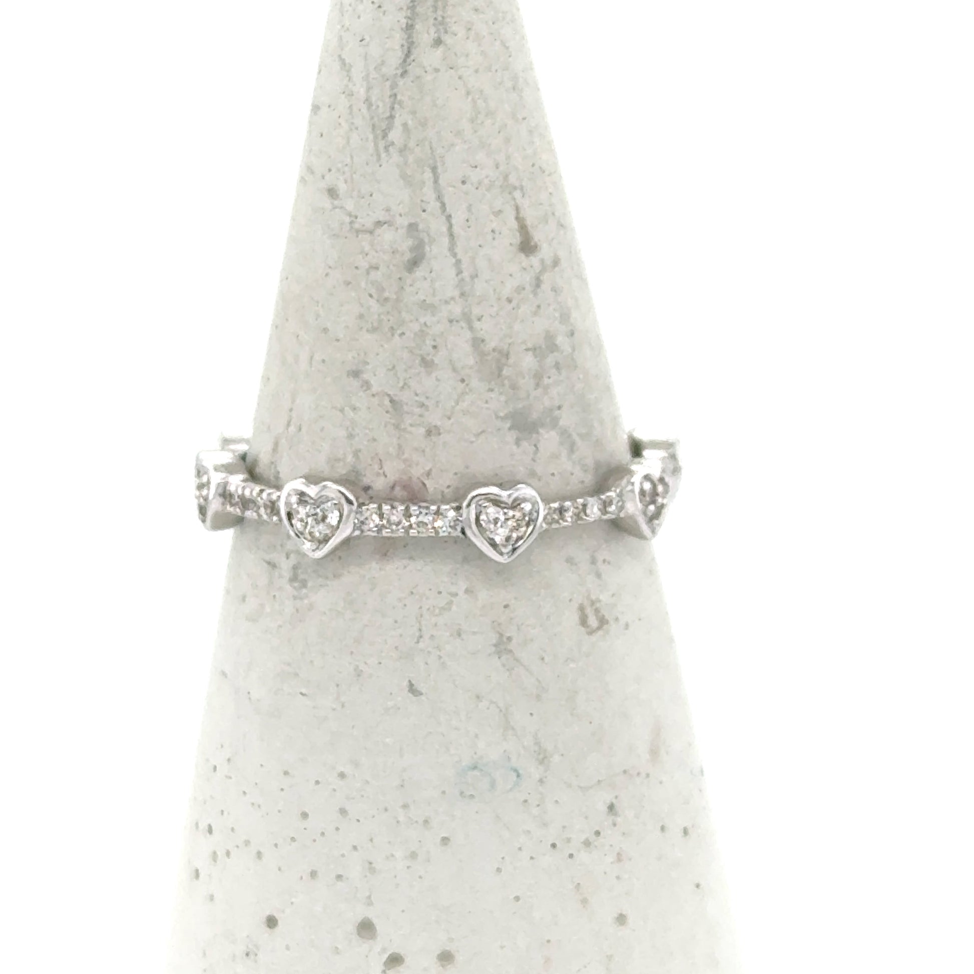 14K white gold eternity band with heart motifs and prong-set round diamonds.