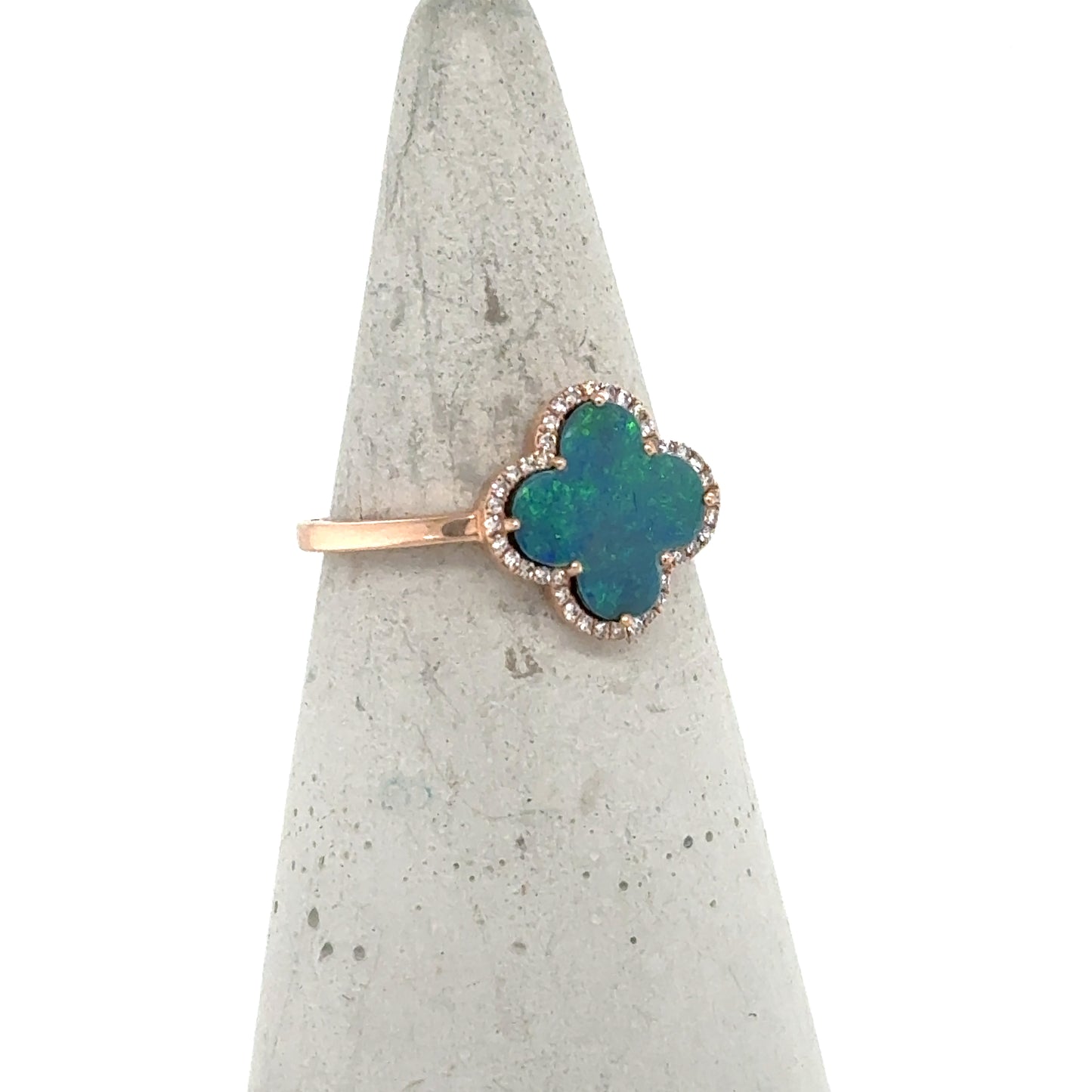14K rose gold ring with blue-green opal clover, diamond halo, slim band.