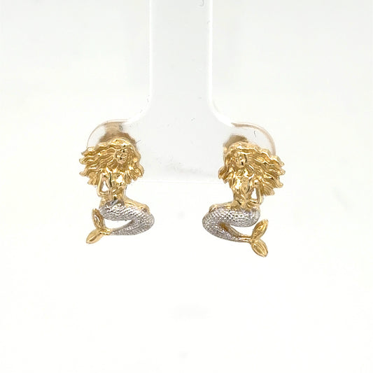 Small 14K two‑tone mermaid stud earrings with yellow gold bodies and rhodium‑plated silver tails.