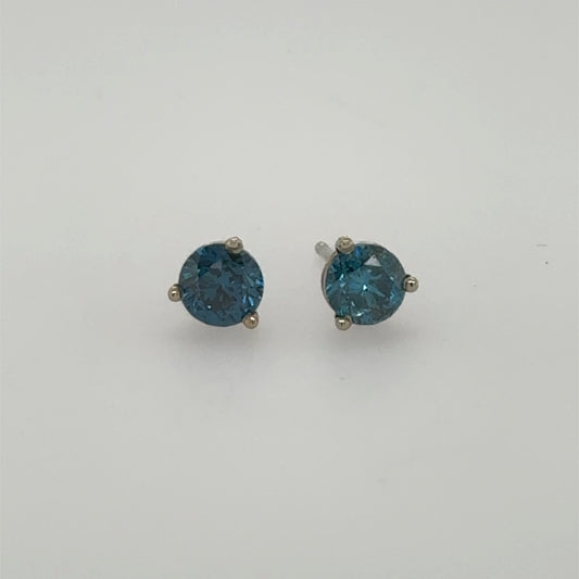 Round blue diamond stud earrings in 14K white gold three-prong settings.