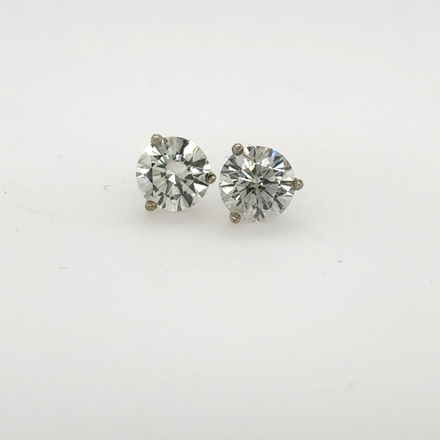 Round brilliant diamond stud earrings in 14K white gold three-prong martini settings.