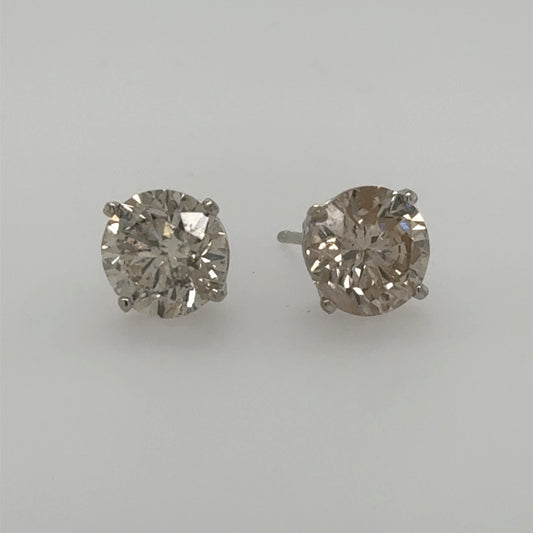 Round diamond stud earrings in white gold four-prong basket settings with posts.