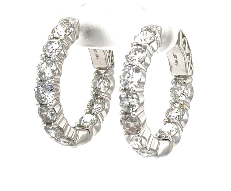 14K white gold inside-out hoop earrings with round diamonds in shared prongs.