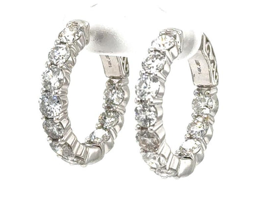 14K white gold inside-out hoop earrings with round diamonds in shared prongs.