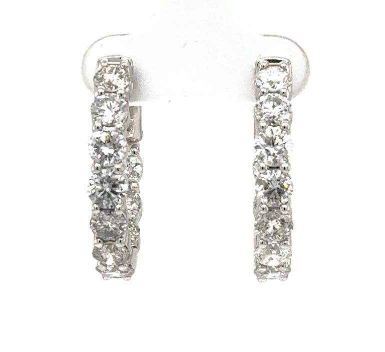 14K white gold inside-out hoop earrings with round diamonds in shared prongs.