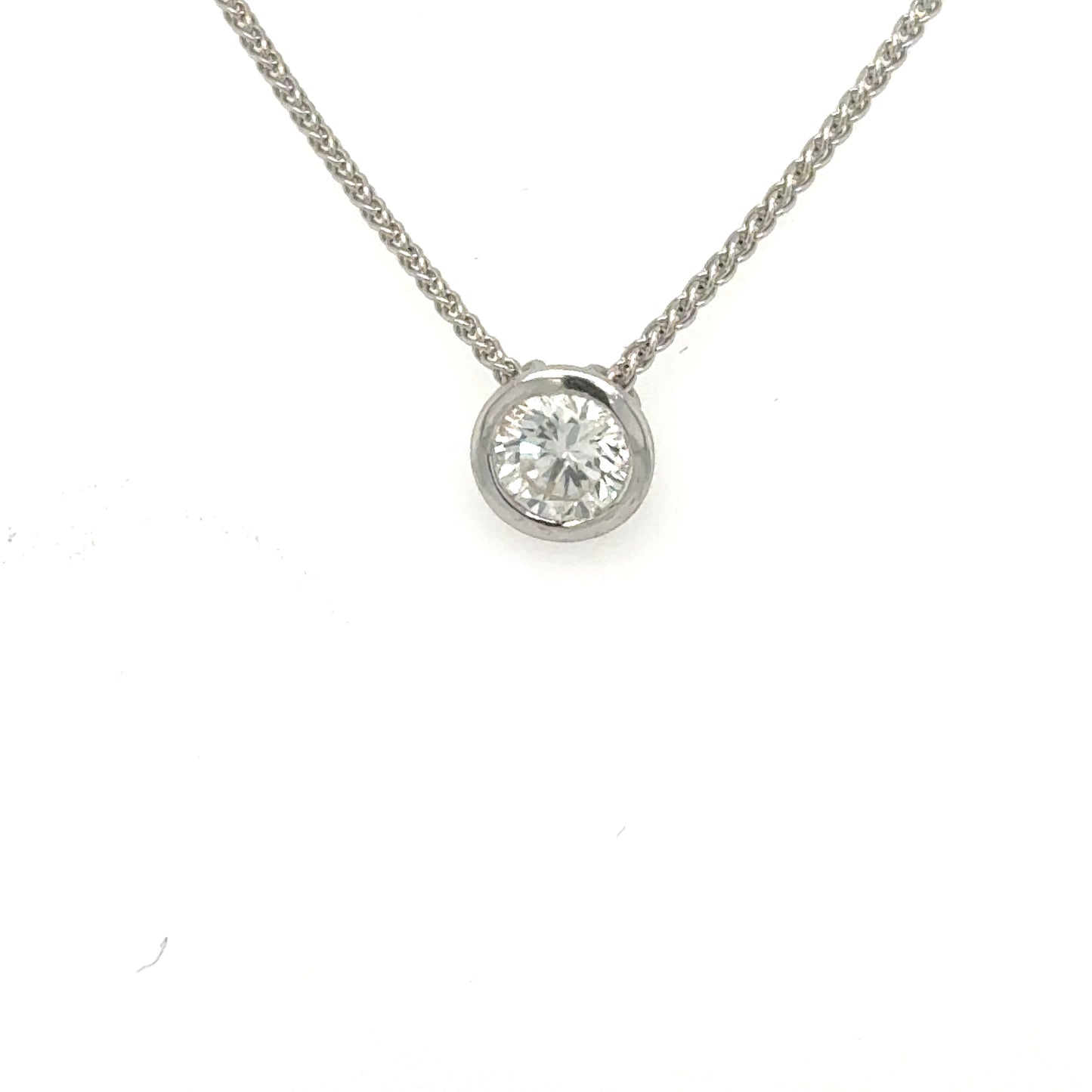 Round brilliant diamond bezel-set in white gold on a wheat chain.