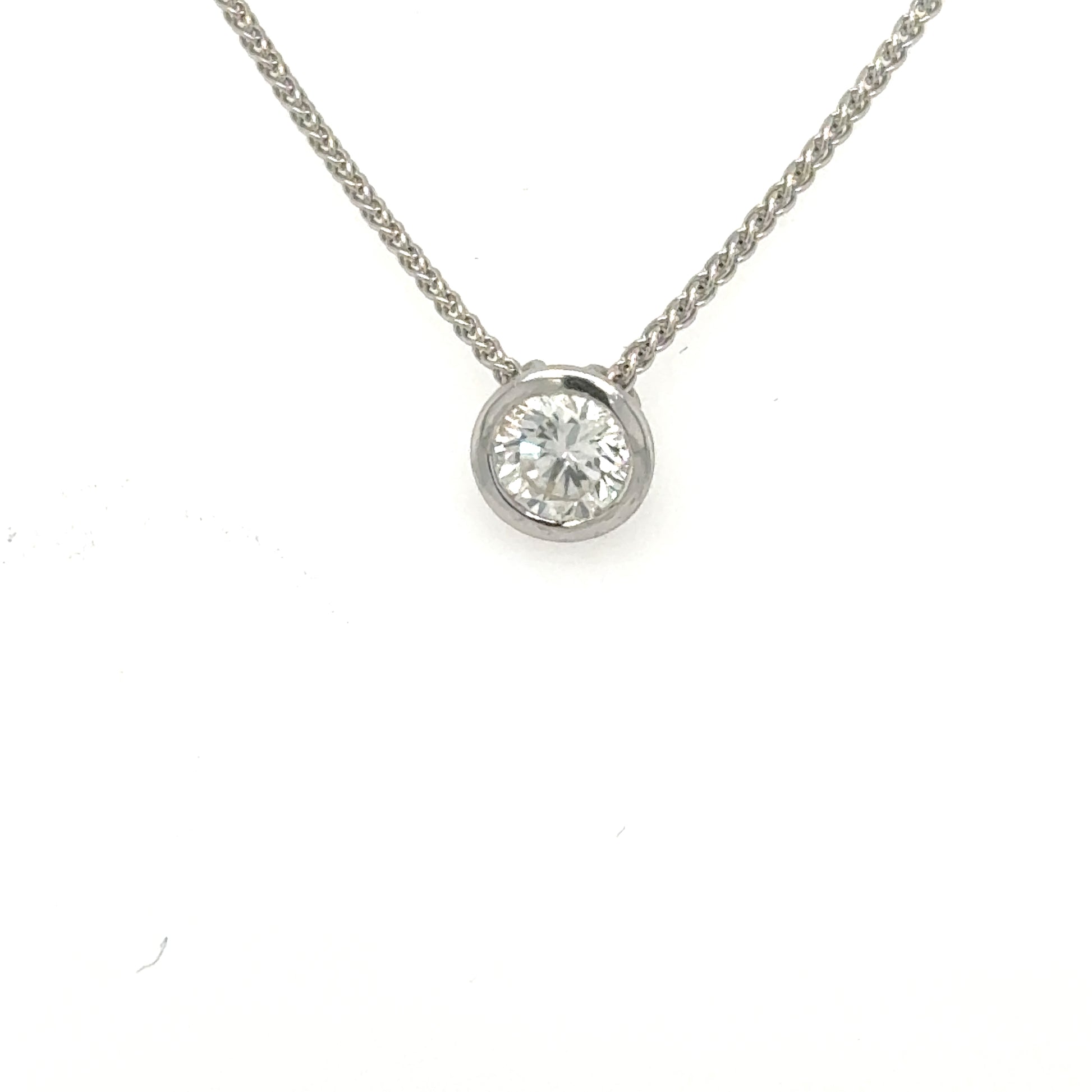 Round brilliant diamond bezel-set in white gold on a wheat chain.