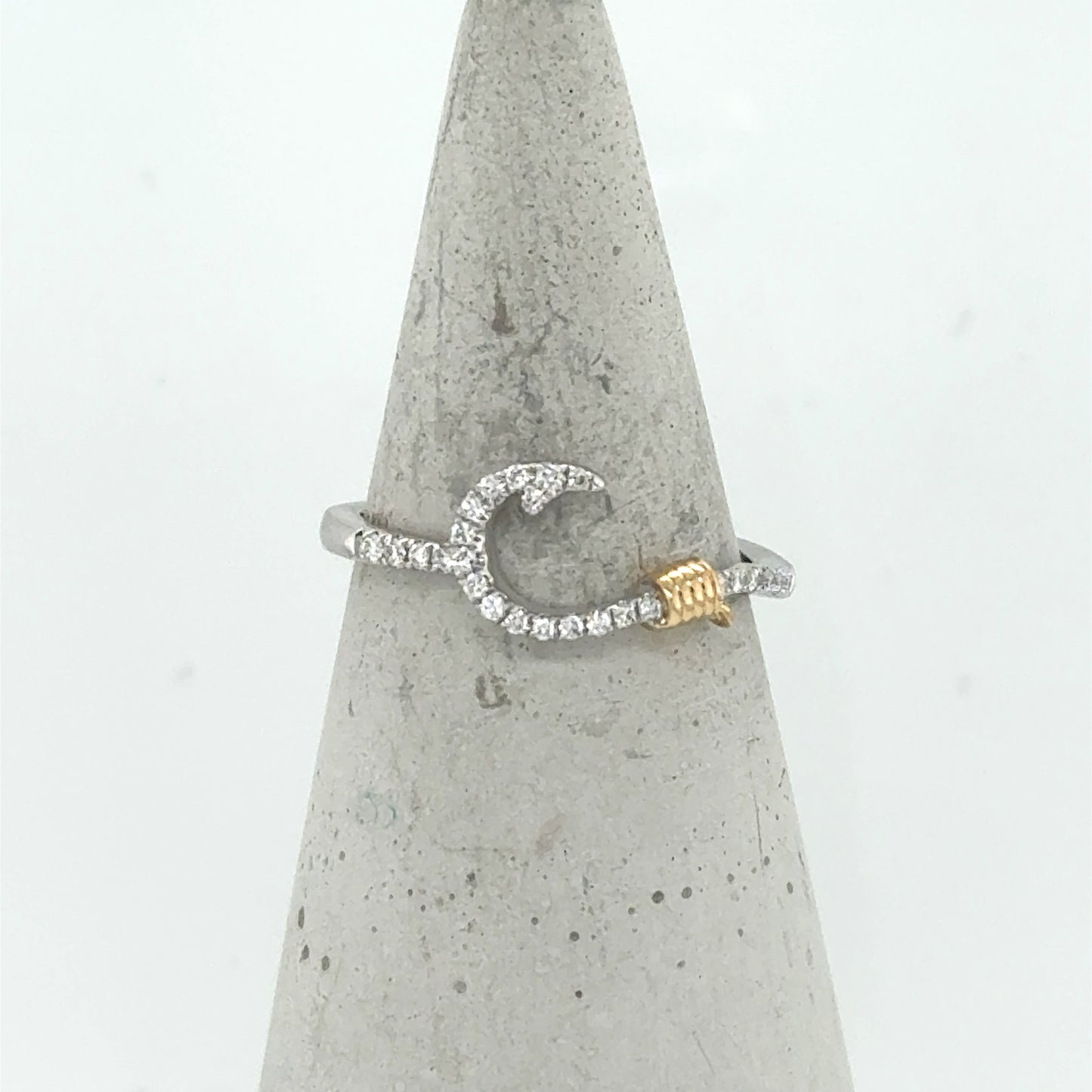 14K white gold ring with diamond fish hook motif and yellow gold rope accent.