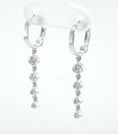 14K white gold hoop earrings with graduated bezel-set round diamond dangles.