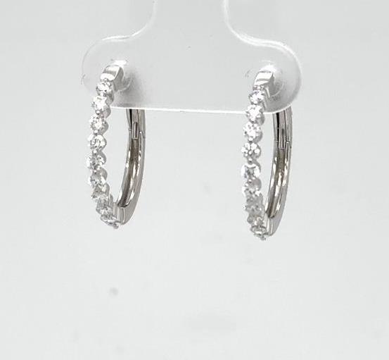 14K white gold diamond hoop earrings with shared-prong fronts and hinged backs.