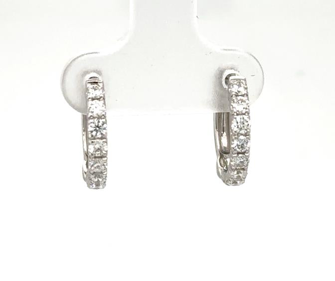 14K white gold huggie hoop earrings with prong-set round diamond fronts.