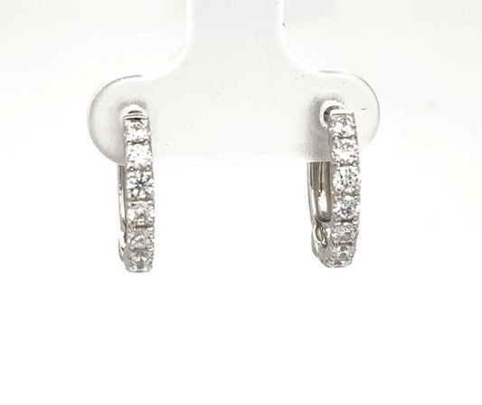 14K white gold huggie hoop earrings with prong-set round diamond fronts.