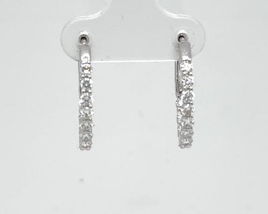 14K white gold oval hoop earrings with inside-out prong-set round diamonds.