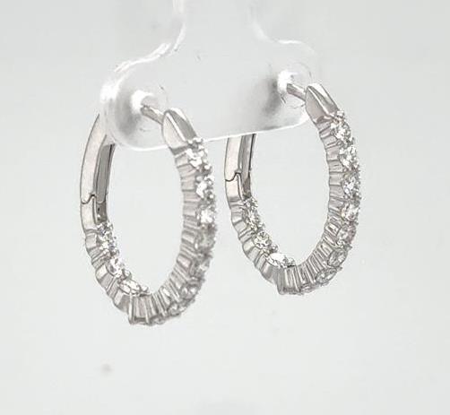 14K white gold oval hoop earrings with inside-out round diamond accents.