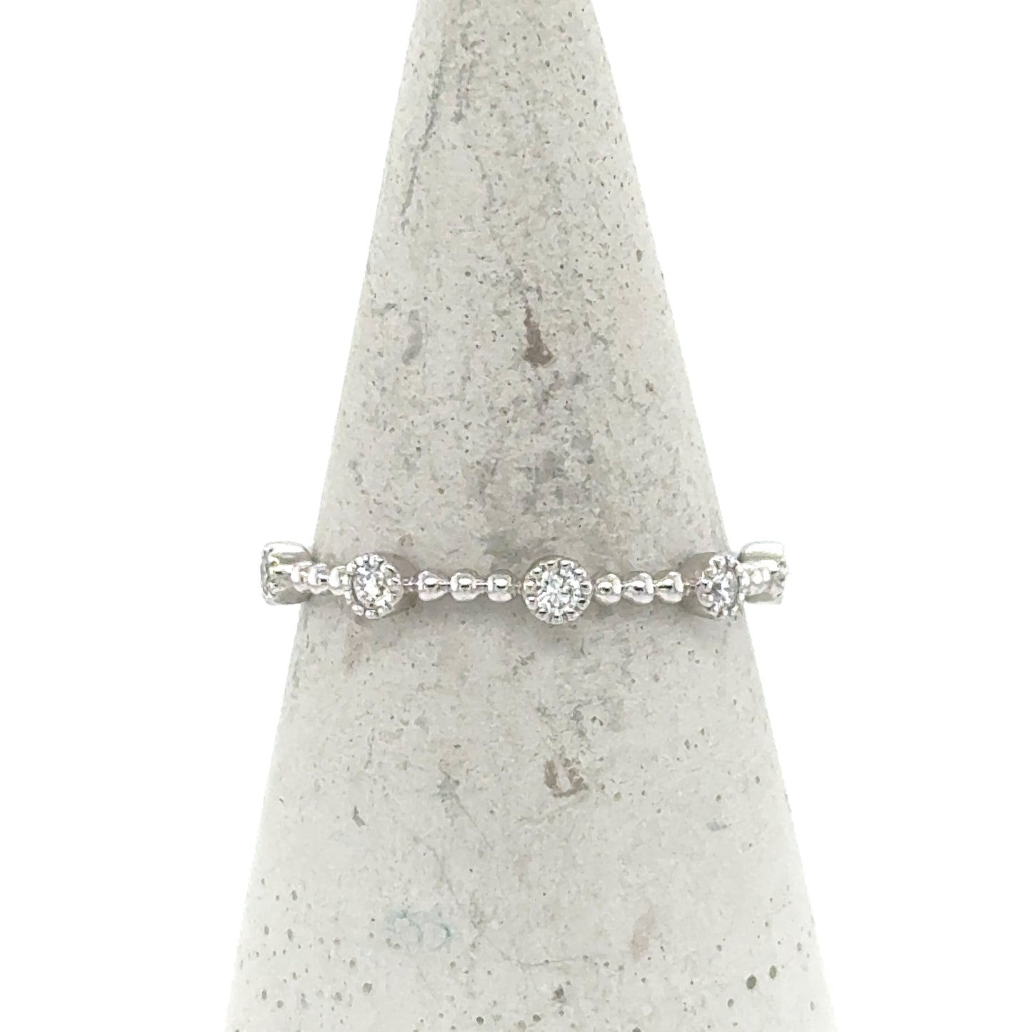 14K white gold stackable band with round pavé diamond stations and beaded shank.