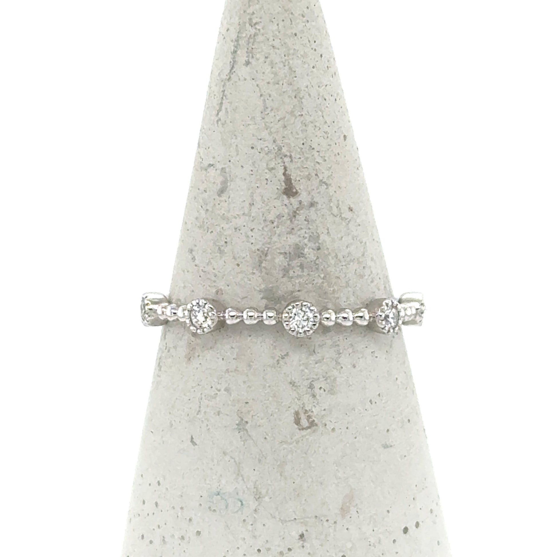 14K white gold stackable band with round pavé diamond stations and beaded shank.