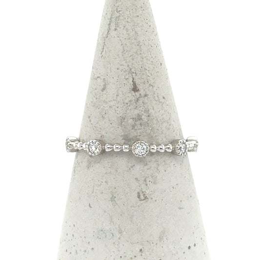 14K white gold stackable band with round pavé diamond stations and beaded shank.