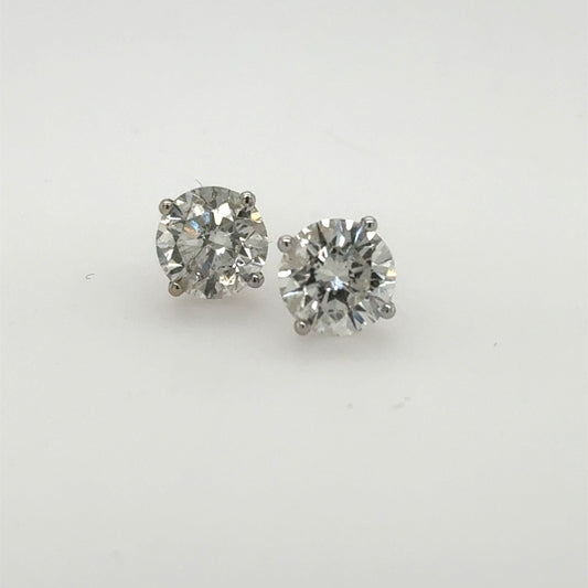 Round diamond stud earrings in 14K white gold four-prong martini settings.