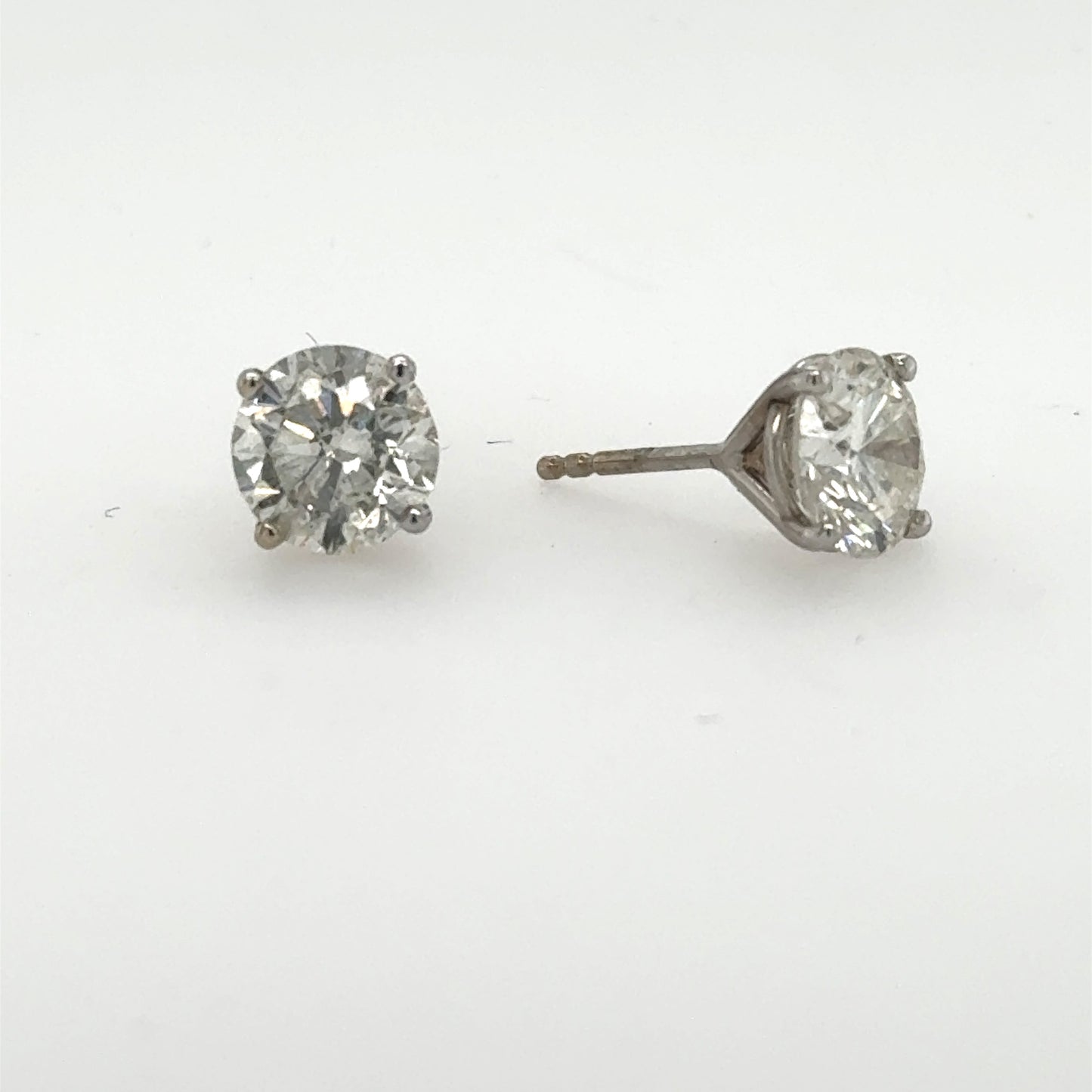 Round brilliant diamond stud earrings in 14K white gold, four-prong martini settings.