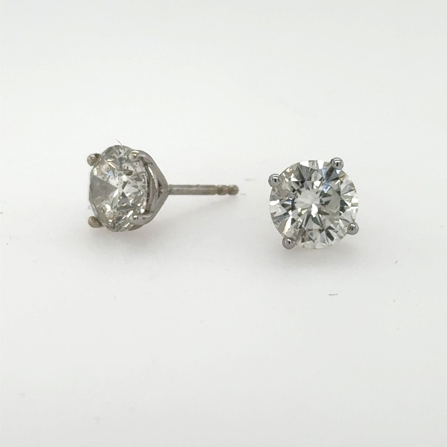Round brilliant diamond stud earrings in 14K white gold four‑prong martini settings.