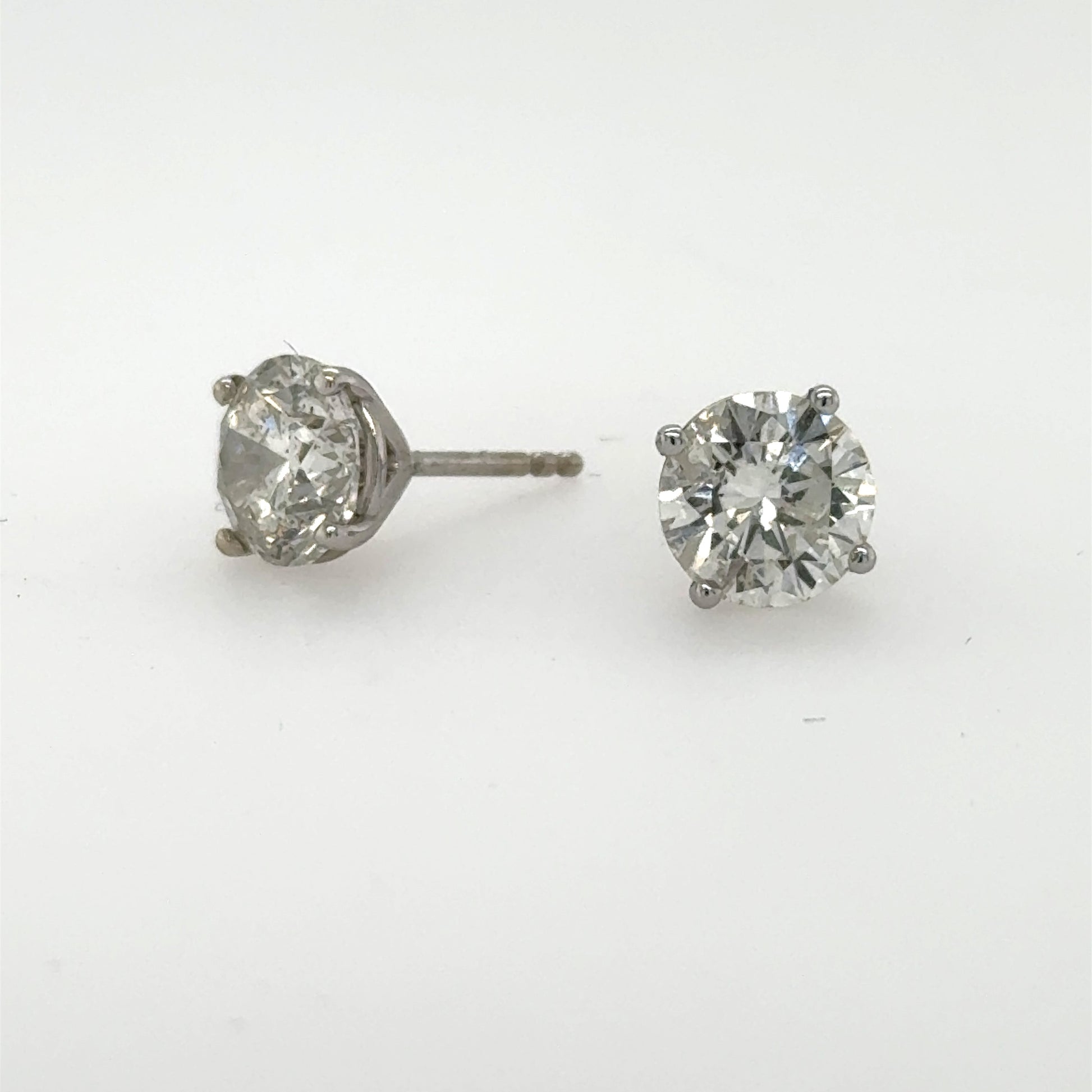 Round brilliant diamond stud earrings in 14K white gold four‑prong martini settings.