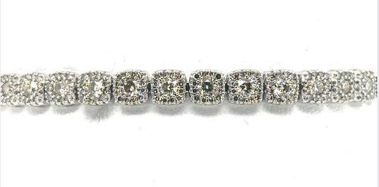 14K white gold tennis bracelet with round diamonds in halo link settings.