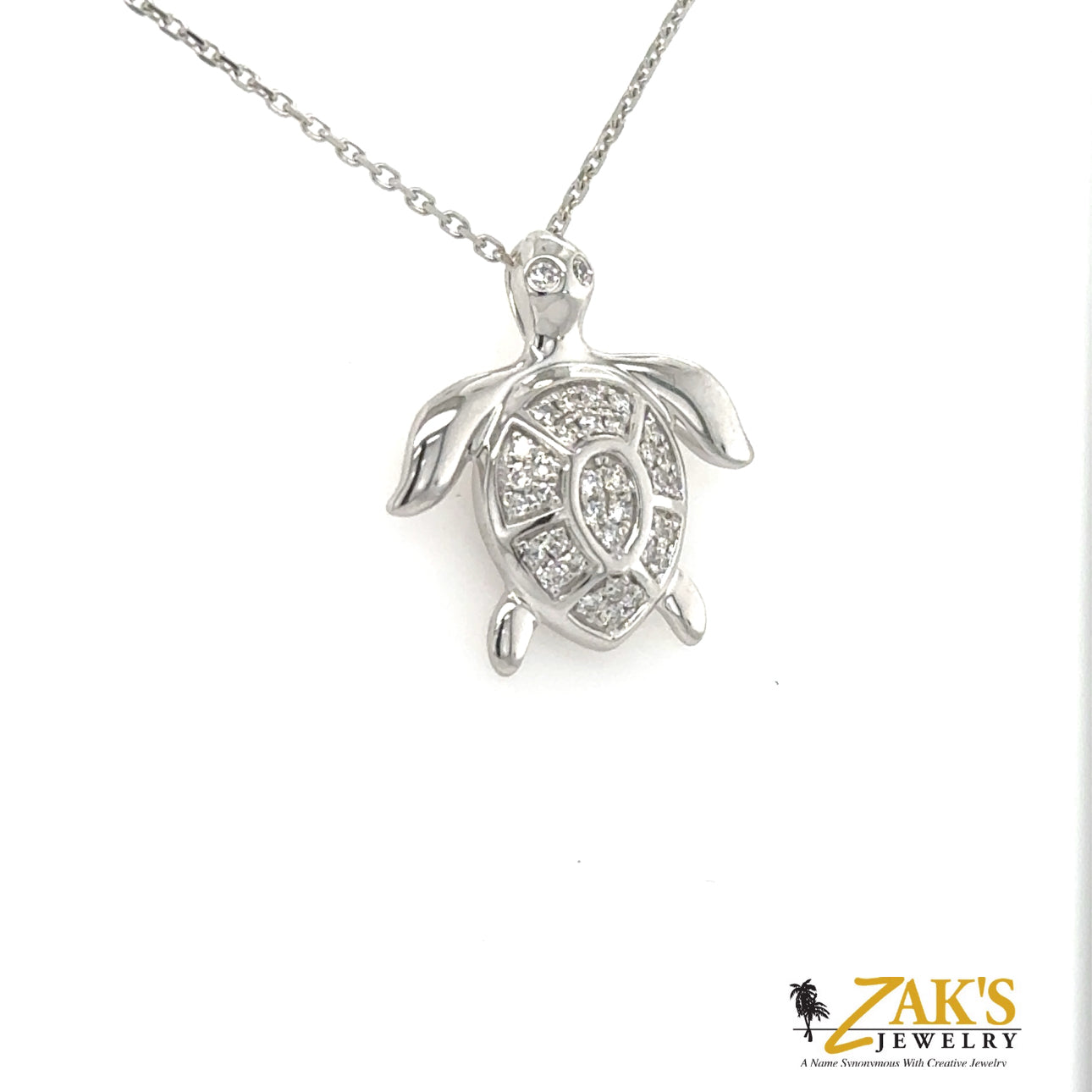 14K white gold turtle pendant with pavé-set round diamonds and hidden bail.