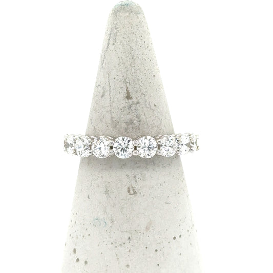 18K white gold band with nine round diamonds in shared-prong setting.