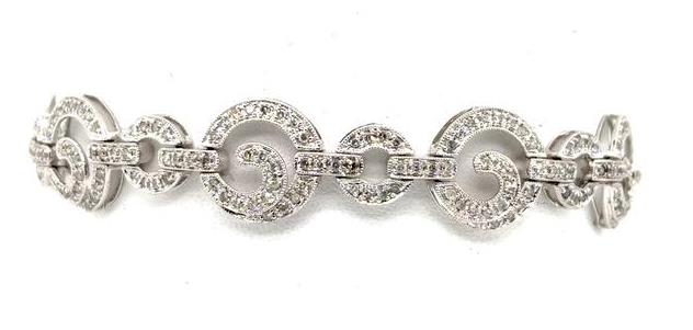 14K white gold diamond tennis bracelet with pavé circle links and prong settings.