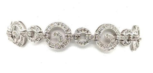 14K white gold diamond tennis bracelet with pavé circle links and prong settings.