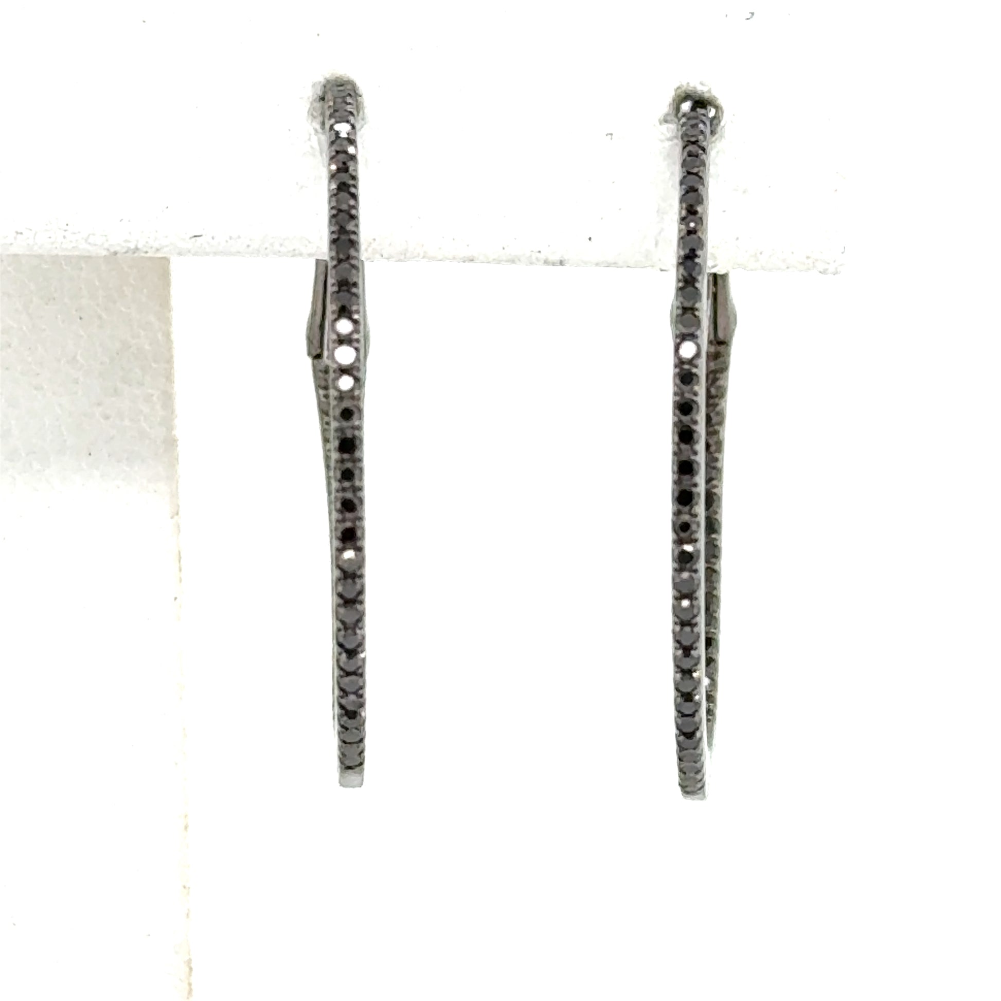 Inside-out hoop earrings with round black diamonds and black rhodium over white gold.