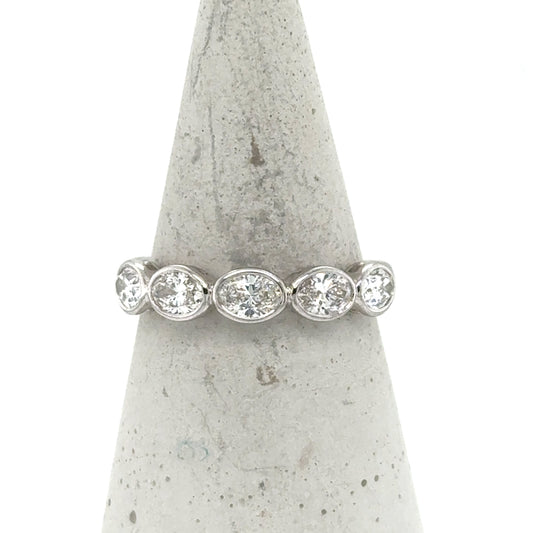 14K white gold band with five bezel-set oval and round diamonds.