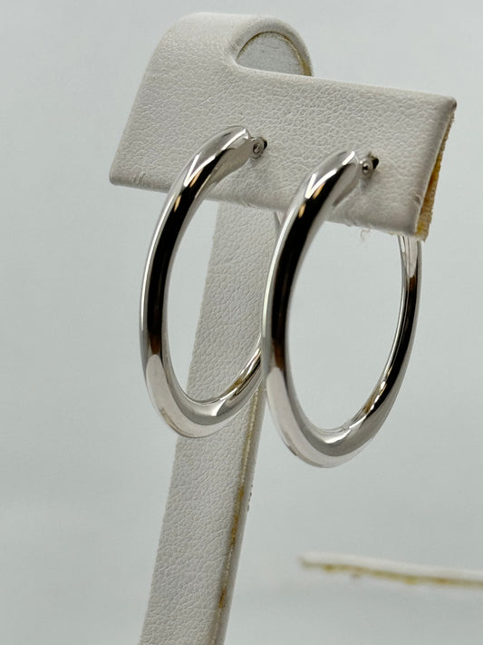 Polished 14K white gold oval hoop earrings for pierced ears.