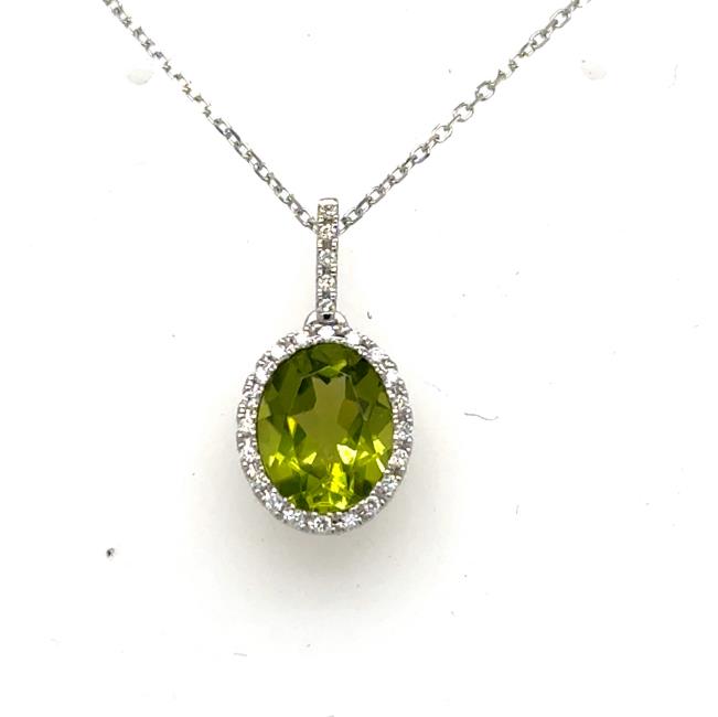 Oval green peridot halo pendant in white gold with diamond-set bail and chain.