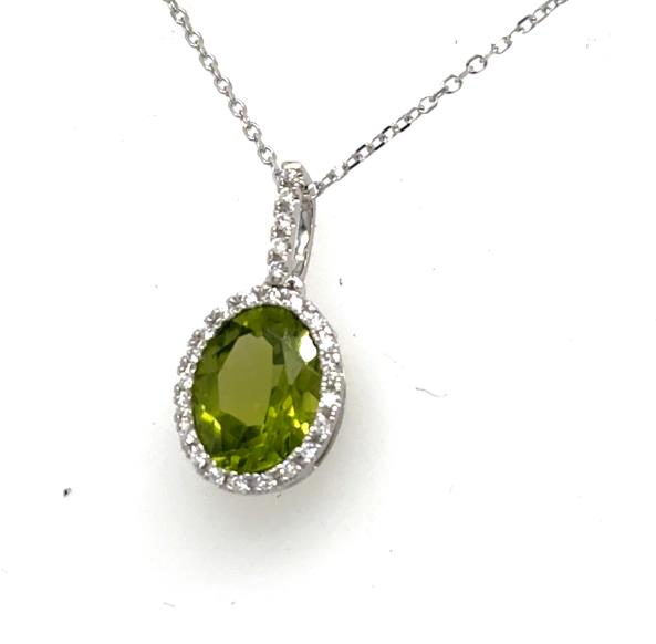 Oval green peridot halo pendant in 14K white gold with diamond-accented bail.